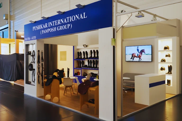 Turnkey exhibition stand with saddle displays and buyer meeting area at NEC Birmingham