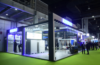 Booth with innovative structure and LED lighting, drawing visitors at Automate Detroit 2025.