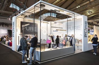 Elegant and modern glass-structured booth showcasing innovative consumer goods at JCK Las Vegas 2025, Messe Frankfurt