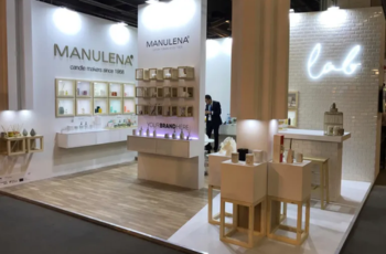 Booth with a warm wooden theme and beautifully arranged product displays, creating a welcoming ambiance at JCK Las Vegas 2025